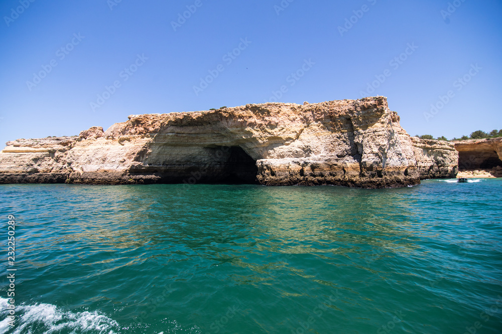 Rocks, cliffs and ocean landscape at coast in AAlgarve, Portugal view from boat