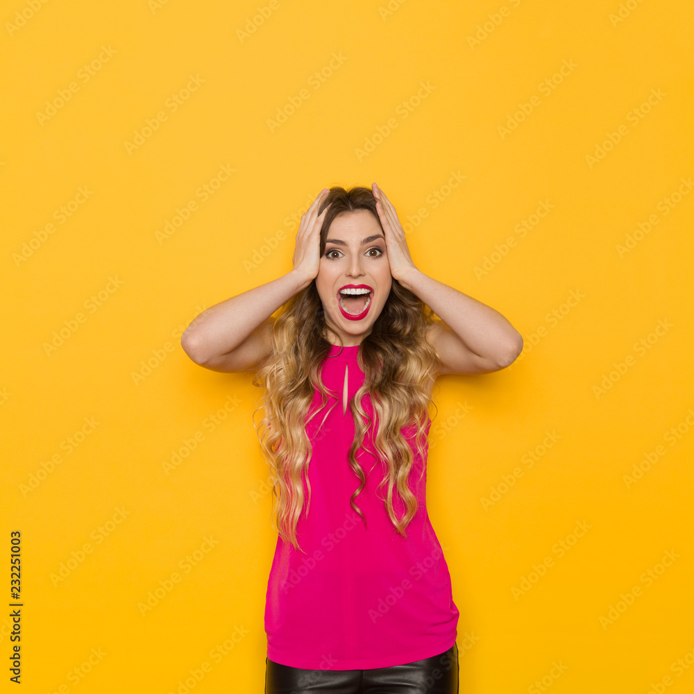 Excited Young Woman Is Holding Head In Hands And Shouting Excited Young Woman Is Holding Head In Hands And Shouting