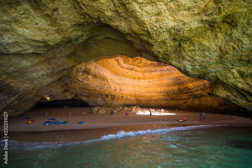 Benagil, Portugal - Juny, 2018: Benagil Cave Boat Tour inside Algar de Benagil, cave listed in the world's top 10 best caves. Algarve coast near Lagoa, Portugal. Tourists visit a popular landmark