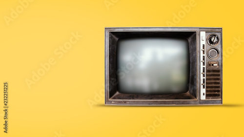 Old vintage tv on yellow background