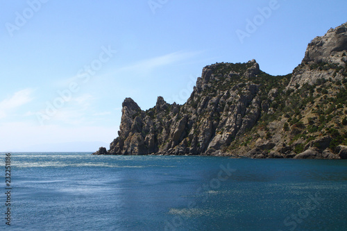 Natural landscape photo of sea and mountains with light blue sky