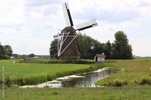 Dutch windmill Victor in polder landscape in the Frisian village Wanswerd.