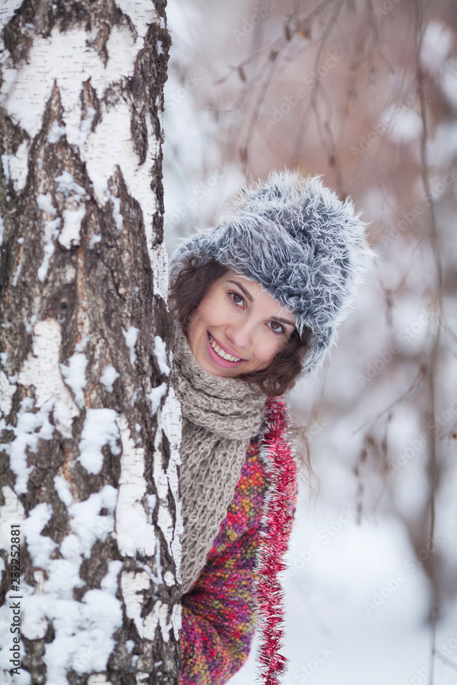 Portrait of a beautiful woman dressed a coat and fur hat in the winter field Portrait of a beautiful woman dressed a coat and fur hat in the winter field