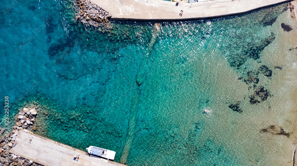  Aerial view of the pier with rocks and cliffs to the sea. panoramic view from above. Summer sea and tourism on the coast of Greece. Mediterranean Sea