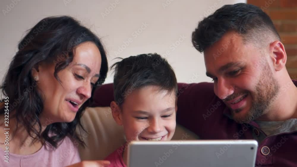 Family having fun watching media on digital tablet Family having fun watching media on digital tablet