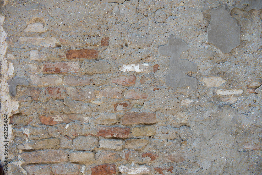 Old dirty wall. Aged italian street wall background with bricks and concrete, texture. Old dirty wall. Aged italian street wall background with bricks and concrete, texture.