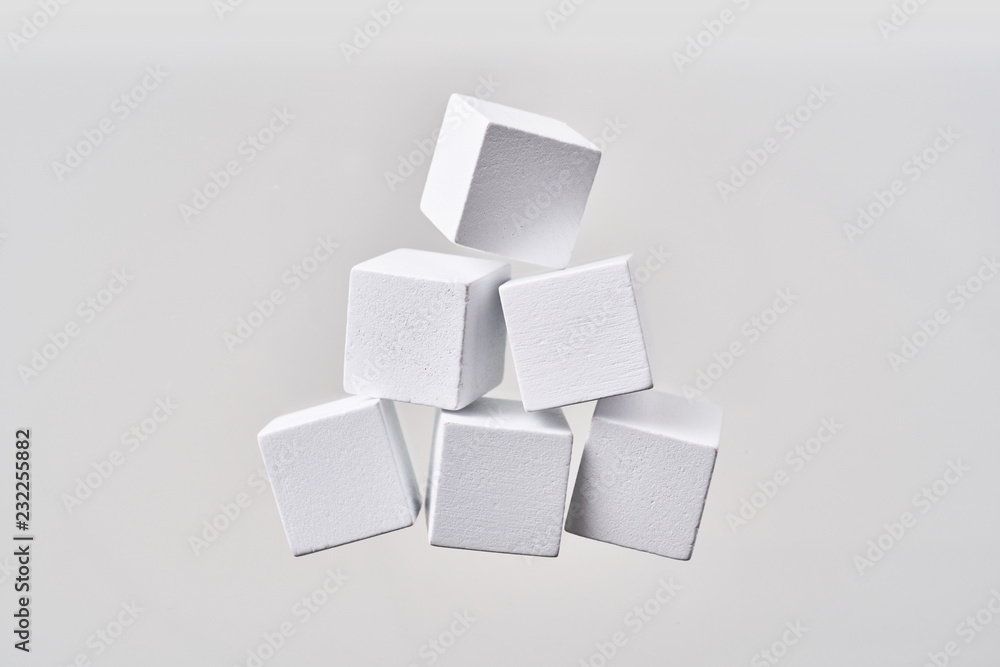 Abstract floating wooden pyramid on white background Abstract floating wooden pyramid on white background