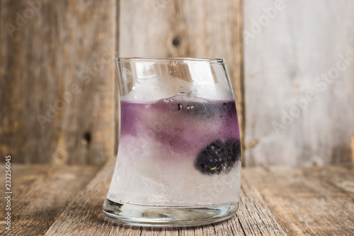 Old fashioned blackberry cocktail on the rustic background. Selective focus. Shallow depth of field.