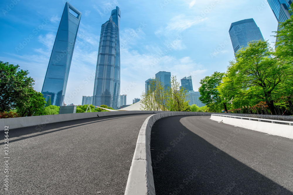 Empty asphalt road along modern commercial buildings in China's cities Empty asphalt road along modern commercial buildings in China's cities