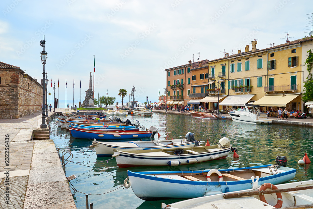 Harbor in city of Lazise with boats / Lake Garda in Italy