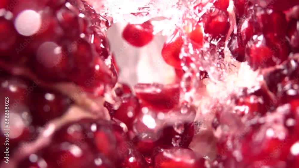 Water flow between pomegranate grains. Slow motion Water flow between pomegranate grains. Slow motion