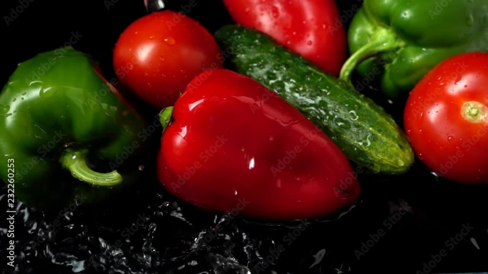 The stream of water flows on vegetables. Slow motion. The stream of water flows on vegetables. Slow motion.