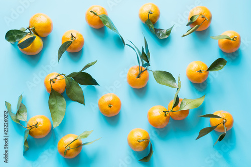 Fresh mandarin isolated on blue punchy pastel. Top view. Fruits pattern.