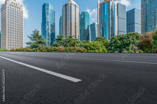 Empty asphalt road along modern commercial buildings in China's cities