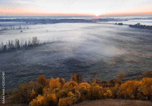 Pink sunrise. Cold morning light. Countryside foggy landscape. Aerial drone photo