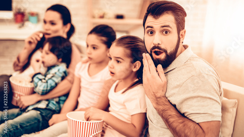 Cheerful Family Watching Scary Movie at Home