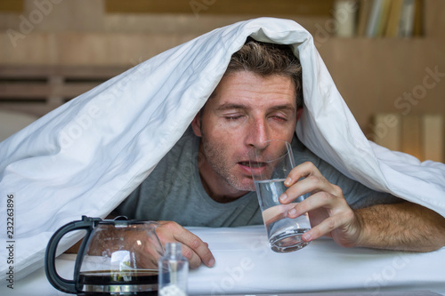 Canvas Print lifestyle home portrait of young exhausted and wasted man waking up suffering he