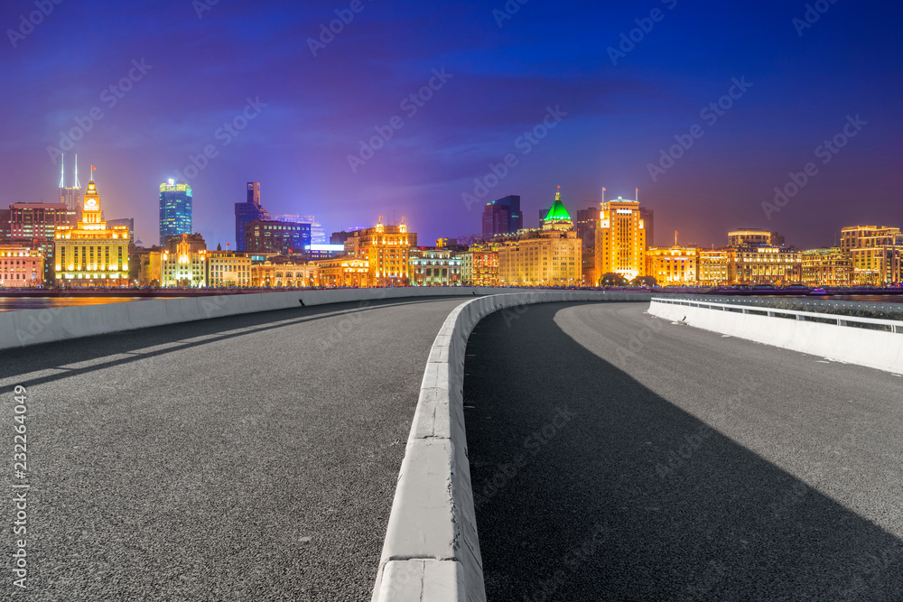 Empty asphalt road along modern commercial buildings in China's cities