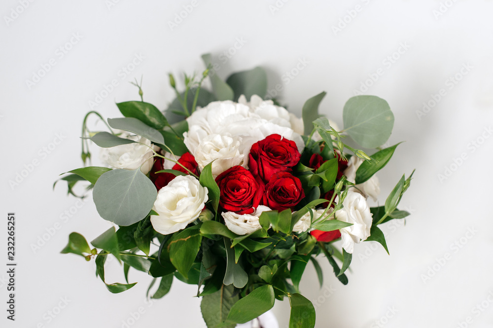 Fototapeta premium Wedding bouquet of white and red roses on a white background