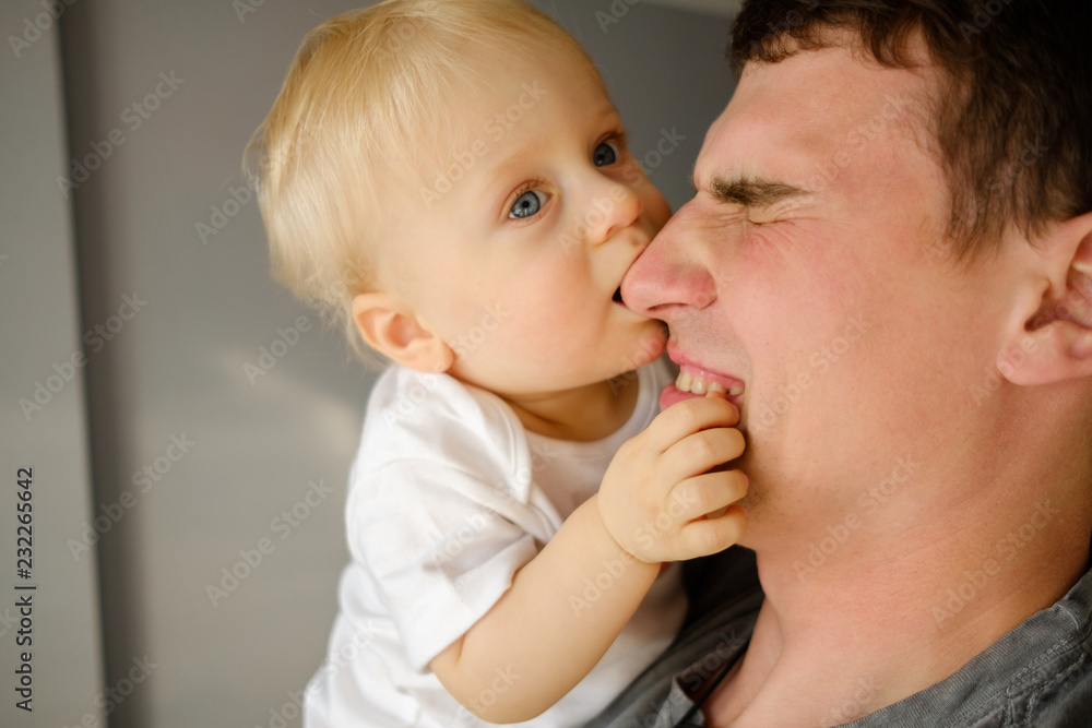 Dad holds the baby in his arms. Embrace of the father and child. Father's Day holiday Dad holds the baby in his arms. Embrace of the father and child. Father's Day holiday