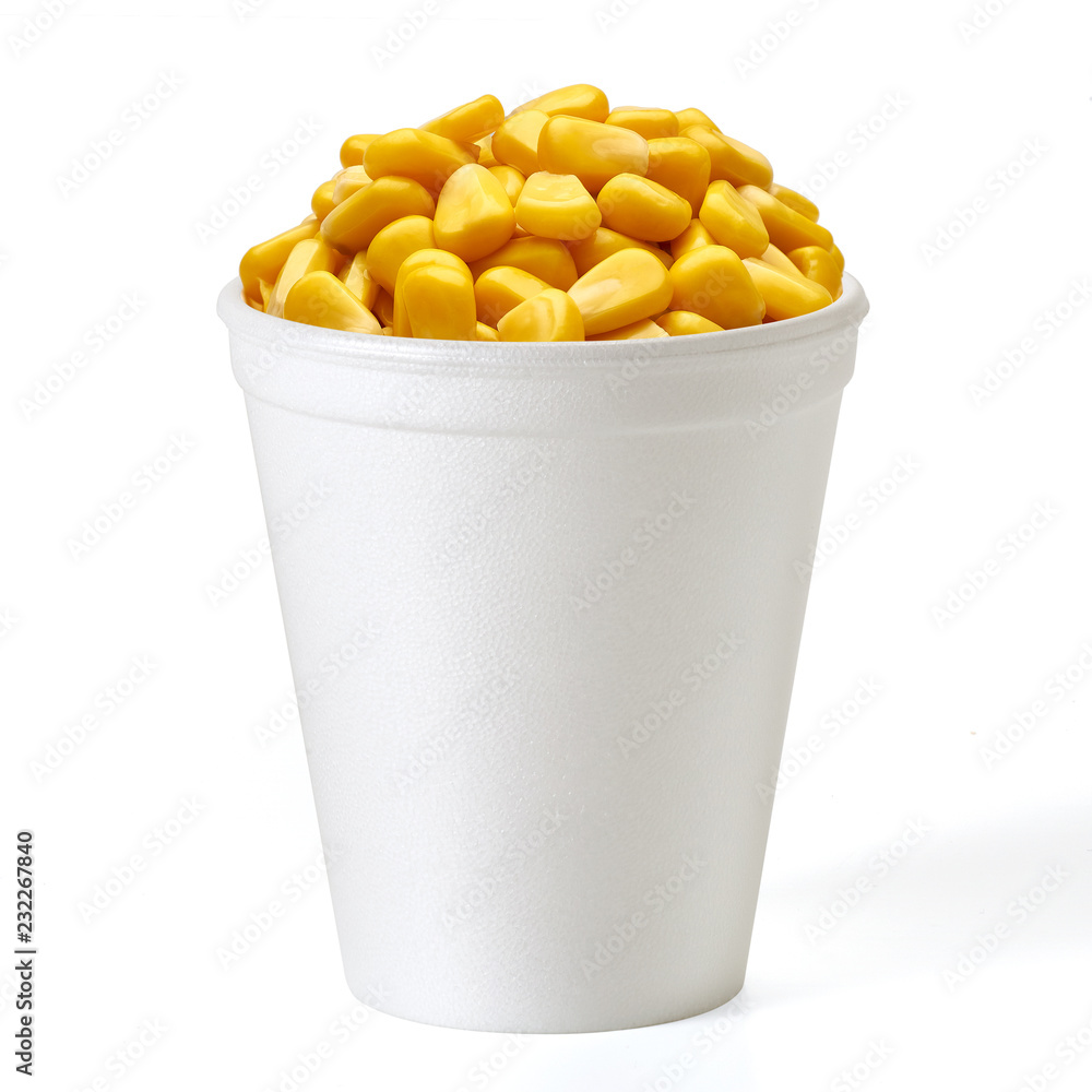 Boiled corn kernels in foam cup side view isolated on white