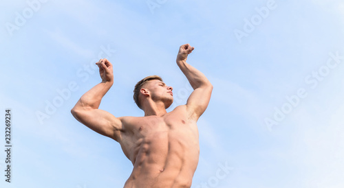 Man muscular athlete bodybuilder show muscles. Bodybuilder shape. Sexy torso attractive body. Strong muscles emphasize masculinity sexuality. Man muscular chest naked torso stand sky background © be free