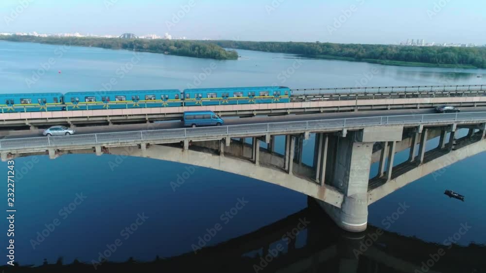 Fly near the subway train on the bridge in Kyiv. Birds eye view