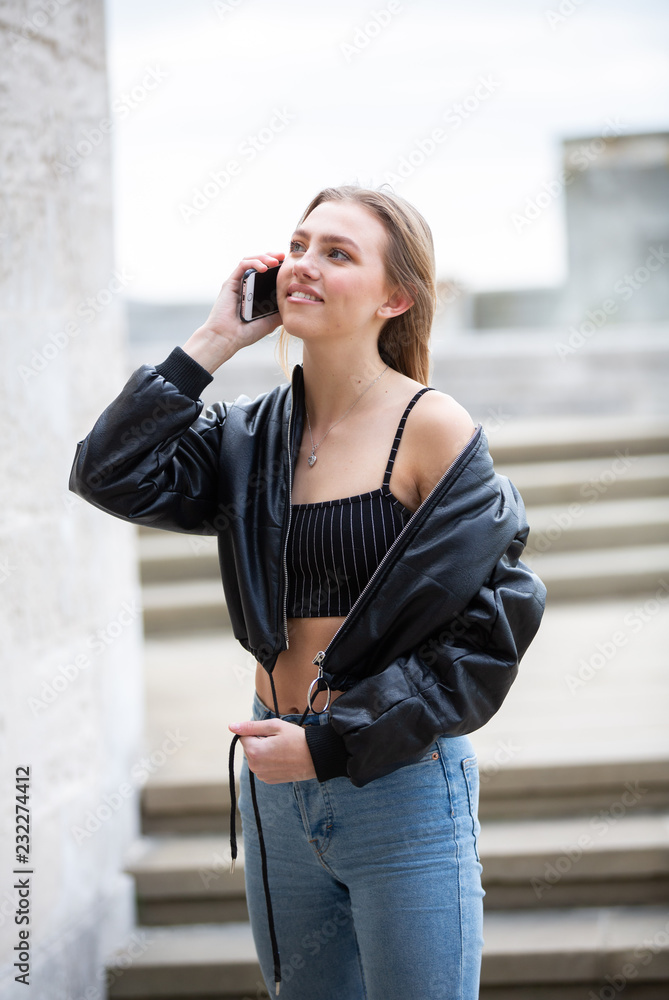 Teenage girl talking on mobile phone happy