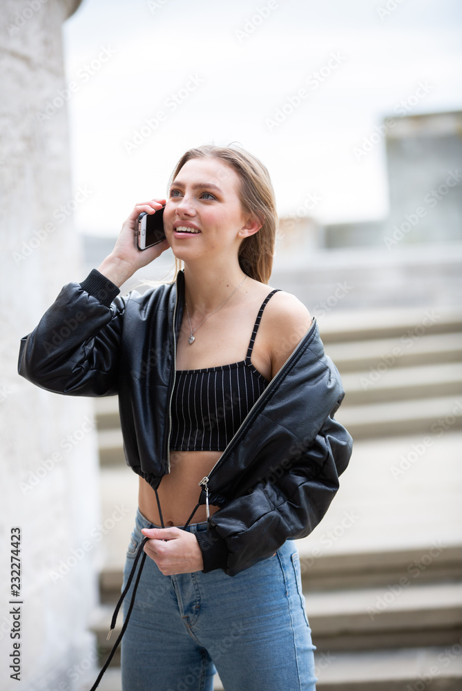 Teenage girl talking on mobile phone happy