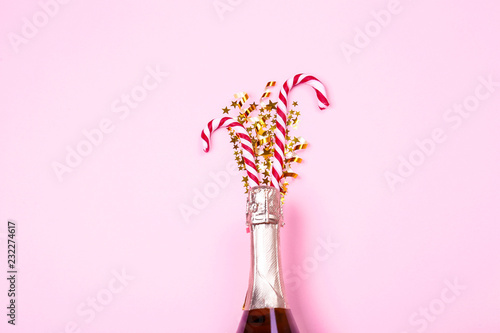 Festive composition with champagne & golden glitter. Traditional New Year celebration. Winter holiday season, christmas time concept. Greeting card mock up. Background, top view, copy space, flat lay