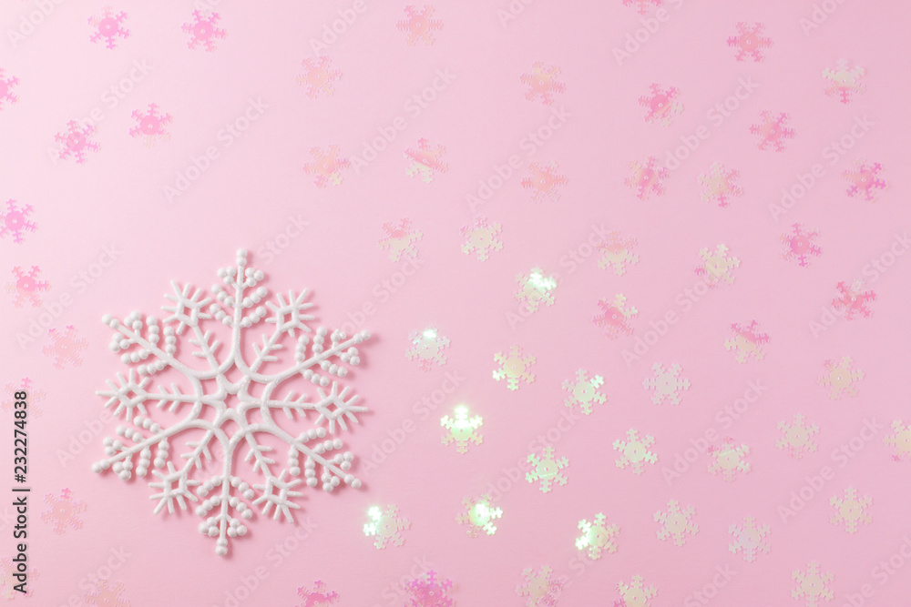 A gentle magic white snowflake from a fairy tale on a light pink background. A gentle magic white snowflake from a fairy tale on a light pink background.
