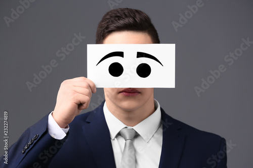 Businessman hiding face beh...