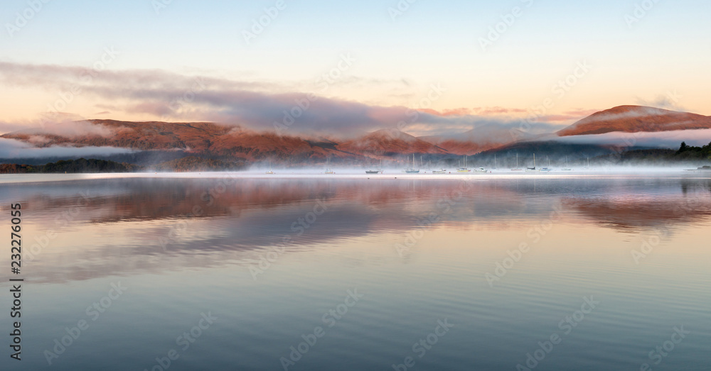A misty dawn over Loch Lomond from Milarrochy Bay A misty dawn over Loch Lomond from Milarrochy Bay