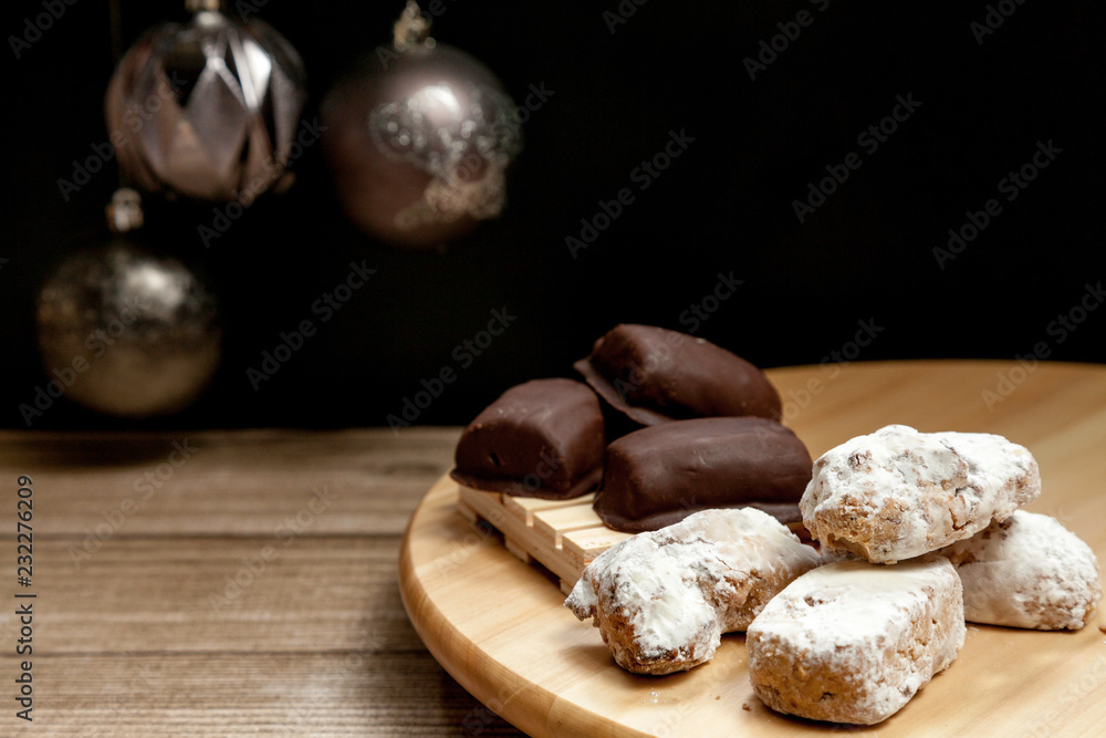typical Spanish almond, almond and chocolate polvorón on black
