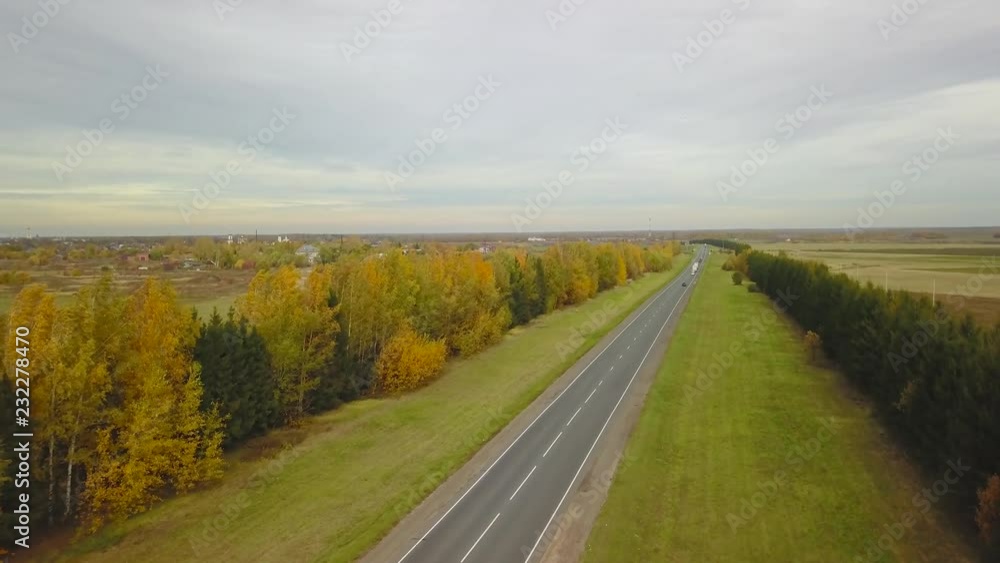 Aerial view country road in autumn forest on rural landscape Aerial view country road in autumn forest on rural landscape