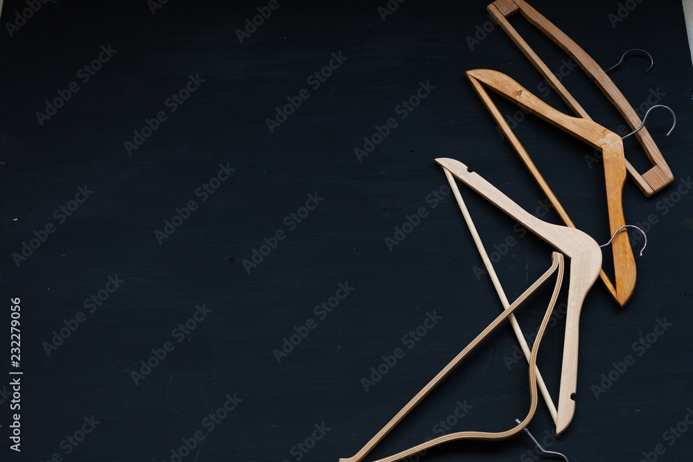 Obraz premium merchandise wooden hangers on a black background