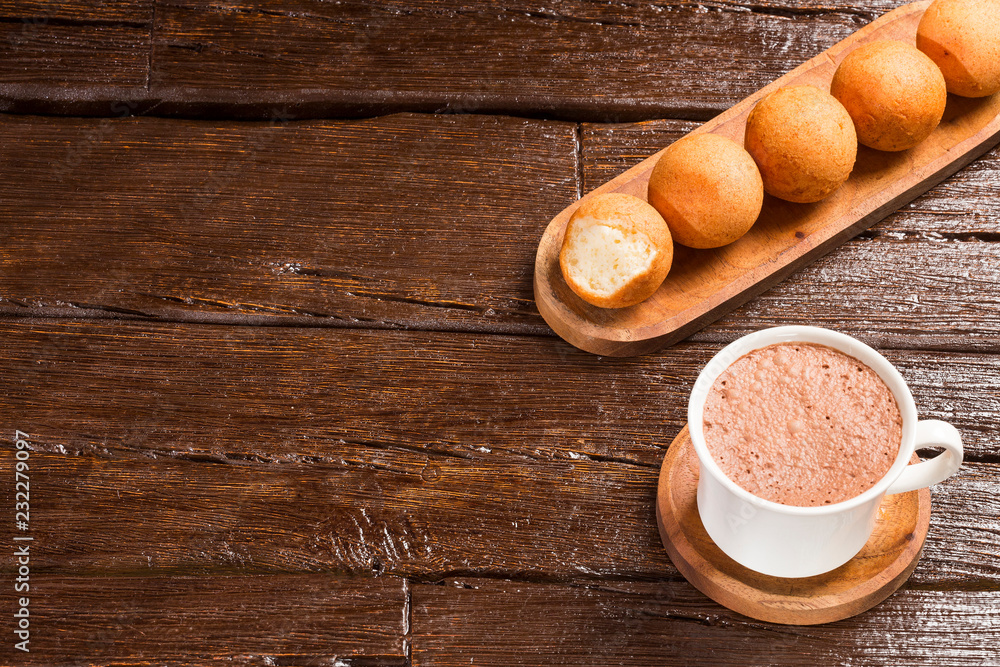 Traditional Colombian buñuelo - Deep Fried Cheese Bread. Hot chocolate drink Traditional Colombian buñuelo - Deep Fried Cheese Bread. Hot chocolate drink