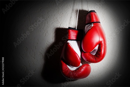 Young businessman with red boxing gloves on  background © BillionPhotos.com
