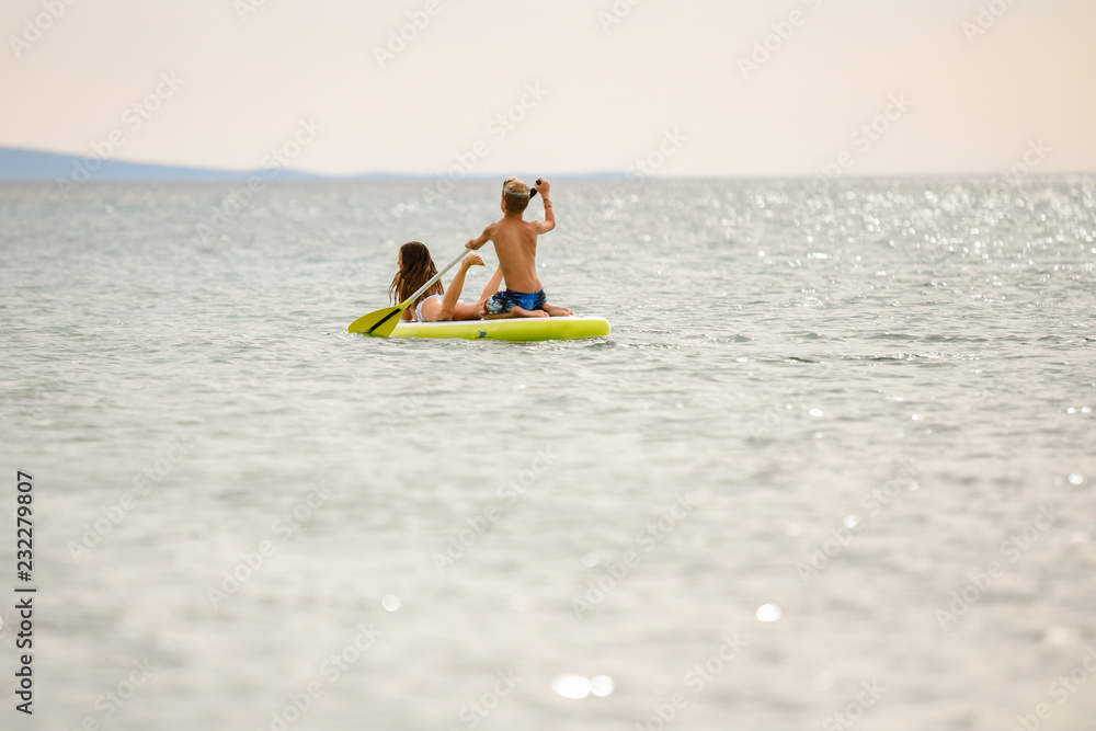 young couple on the stand up paddle board