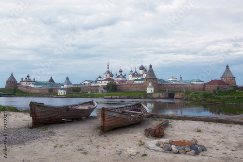 Two old wooden boats on the background of the Solovetsky Monastery, Russia