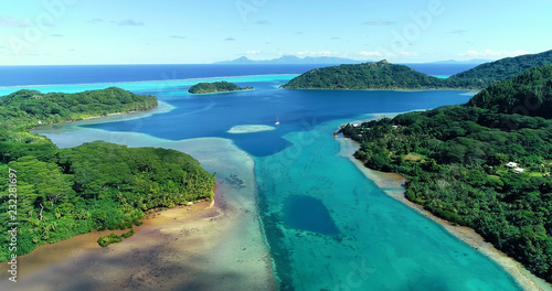 Summer island in the Pacific with lagoon. Perfect view for travel and tourism in French Polynesia - aerial view with a drone - Vacation and tourism concept