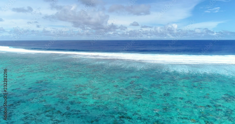 wave in a lagoon in aerial view, french polynesia