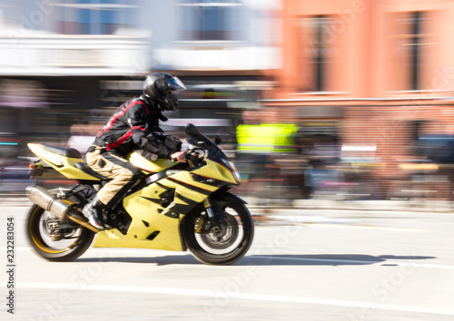 Biker riding motorcycle at sunny day