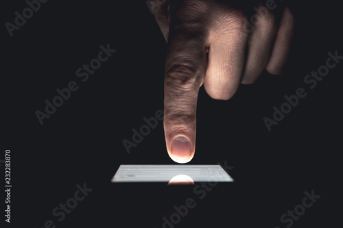 Hand with forefinger pointing on touch screen
