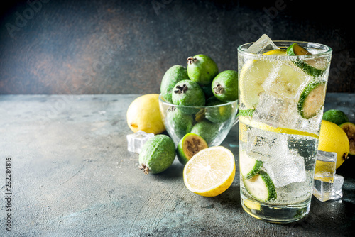 Iced feijoa lemonade on dark blue concrete background copy space photo