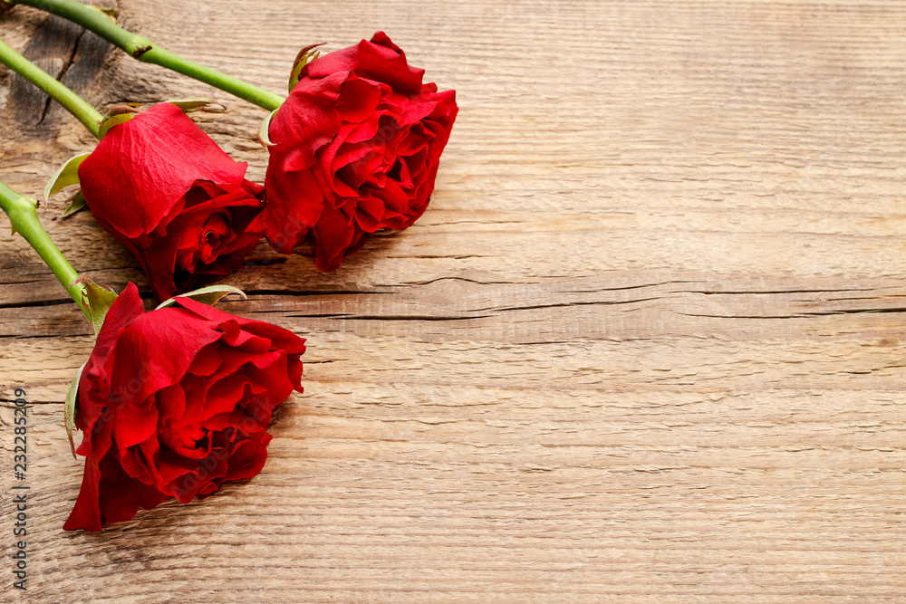 Red roses on wooden background Red roses on wooden background