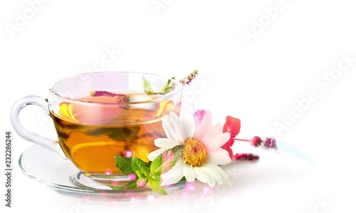 Glass cup of tea with daisy flower
