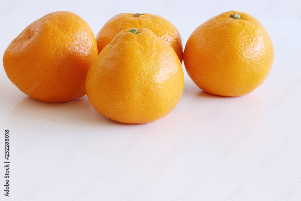 Mandarins on a white wooden background. Rich of nutritions, fiber, and vitamins. Picture design for foods background. Mandarins on a white wooden background. Rich of nutritions, fiber, and vitamins. Picture design for foods background.