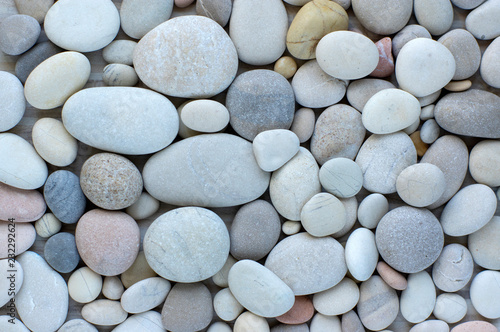 Group of white, grey and black pebbles, one by ony, simplicity stone background