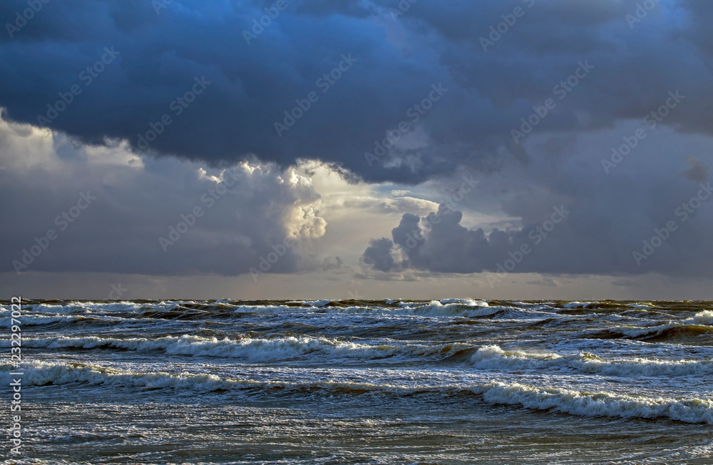 Beautiful evening clouds over the storming Bali Sea